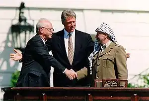 Image 89Israeli Prime Minister Yitzhak Rabin, United States President Bill Clinton, and Palestine Liberation Organization (PLO) Chairman Yasser Arafat during the signing of the Oslo Accords on 13 September 1993. (from 1990s)