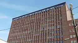 Image of a multistory brown brick square building