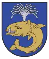 A coat of arms depicting a sea creature with sharp teeth, one protruding bottom tooth, and a blowhole spewing water