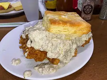 Biscuit with fried chicken thigh & sausage gravy at Biscuit Love in Nashville, TN