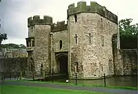 Gatehouse and boundary wall with bridge over moat