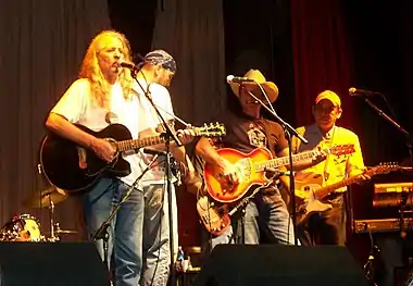 Bob Childers on stage with the Red Dirt Rangers (John Cooper, Brad Piccolo, Ben Han) at the Woody Guthrie Folk FestivalJuly 11, 2007