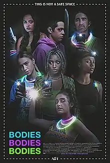 The principal actors standing around one another in the dark, wearing glowsticks and holding up the flashlights on cellular mobile phones