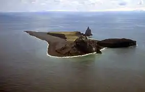 Aerial view of irregularly-shaped island with prominent rocky outcroppings