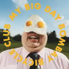 A suited man with eggs on his eyes