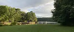 buildings viewed across a green lake