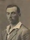 black&white studio photo of a man looking directly into the camera