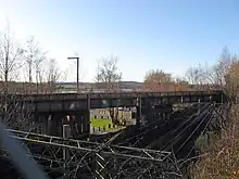 To the east of the station, the former railway line crosses over the North Clyde Line.