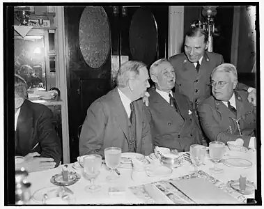 Former Boy Scouts get together. Washington, D.C., May 21. Boy Scouts of yesteryear, whose path led to the Nation's legislative halls, got together this morning for an old-fashioned breakfast of ham and eggs, the breakfast was held at the Senate restaurant, the occasion of the breakfast was a discussion of the Boy Scout Jamboree to be held in Washington, left to right: Sec. of Commerce Daniel Roper; Sen. William Gibbs McAdoo, D. of Calif.; James L. West, Pres. of the National Boy Scouts; and standing is Rep. Sol Bloom, New York