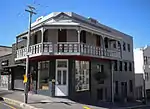 Type of site: Commercial Current use: Shop. In its present form this Victorian double-storeyed shop building with its cast-iron balcony dates from the end of the nineteenth century.