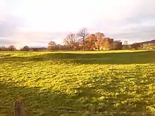 Image 59The banks of Brocavum Roman fort in the foreground; Brougham Castle is in the background (from History of Cumbria)