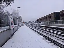 Brockley station's platforms covered in snow after a stormy night, December 2022