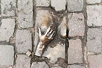 Bronze relief in the cobblestone of Oudekerksplein.