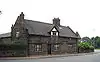 A low stone single-storey house with a dormer