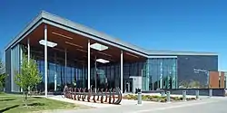 A modernist metal-and-glass building with a large covered entryway