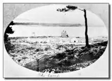 black and white postcard of the site, with the sea in the background