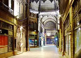 A rather Gothick 18th-century indoor mall, with high round-arched ceilings and ornate pendants from the roof.