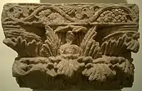 Buddhist pillar capital from Surkh Kotal, with central Buddha figure.