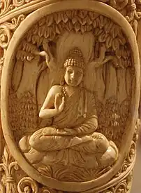 Buddha seated under a tree in Abhayamudra