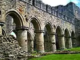 Exterior view of the nave from the south west, showing the bluntly pointed arches. Central tower to right.