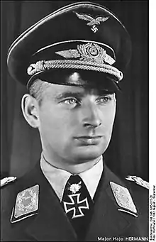 Black-and-white portrait of a man wearing a military uniform with an Iron Cross displayed at his neck.