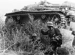 Battle of Stalingrad: Infantry and a supporting StuG assault gun advance towards the city center.