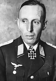 A man wearing a military uniform with an Iron Cross displayed at the front of his uniform collar.