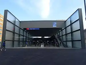 Square two-story glassed-in entrance to underground station