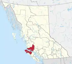 A map of British Columbia depicting its 29 regional districts and equivalent municipalities. One is highlighted in red.