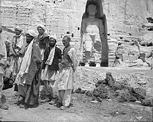 Local men standing near the larger "Salsal" Buddha statue, c. 1940