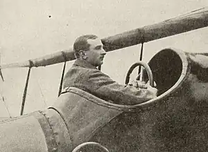 man sat in cockpit of old aeroplane