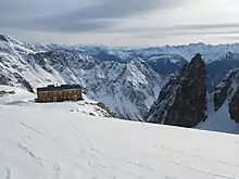 mountain refuge overlooking snow-covered Swiss mountains