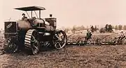 A photo of a 1910 80 hp Caldwell Vale tractor. It featured four wheel steering and an additional cooling tank mounted on the rear, suggesting that the front radiator alone was insufficient to maintain a normal working temperature for the engine.