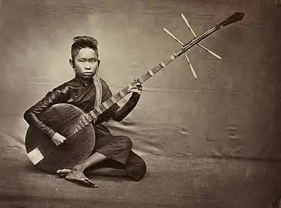 Cambodian musician playing Chapei Dang Veng in between 1860s-1870s