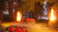 Staff performing a skit at a campfire