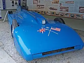 A front right view of a blue coloured racing car.