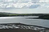 Campbeltown Loch and Campbeltown. Looking down from the top of Davaar. In the foreground is the Doirlinn, then the loch. On the western side of the loch is Campbeltown and beyond that Machrihanish Bay can be seen.