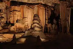 This famous attraction is situated in the Cango ward 29 kilometres north of Oudtshoorn.
The entrance is in the face of a hill beside the Grobbelaar's River.
The maze of caves with their beautiful stalactite formations are most impressive.
It is generally accepted that the Caves were discovered in 1780 by a herdsman of a farmer called Van Zyl of Doornrivier (now Herold) while he was looking for lost cattle.
Later, this man paid a second visit to the caves accompanied by a schoolmaster.
Type of site: Karst cavern