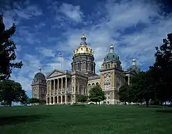 A photography of the entire building. The building is of stone with columns, cornices and capitals. Refer to caption and link for more.