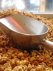 Large aluminum scoop, here with caramel corn