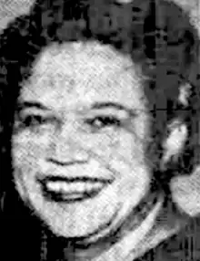 A smiling Black woman, from a 1965 newspaper photograph