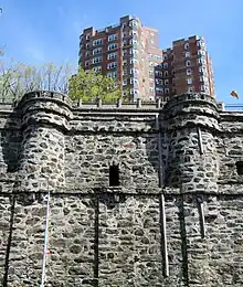 The retaining wall from the estate is still used for Castle Village, seen behind it.