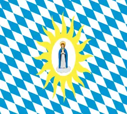 Virgin Mary, praying on a cloud, crowned with a glory; on a white oval; surrounded by a glory of yellow rays; on a field of white and blue lozenges, Bavarian style