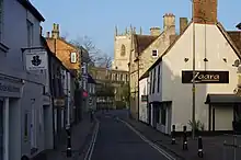 A series of vernacular buildings either side of a narrow street