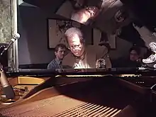 Man sitting in front of a piano.