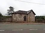 Small stone building at cemetery entrance