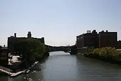 The two largest buildings and bridge included in the district, viewed from up the river