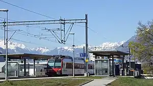 Canopy-covered platforms with red-and-white train