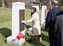 The memorial is a bronze plaque with the faces of the crew mounted on the front of a tombstone