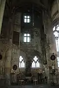 North chapel, with the remains of the rooms used by the monks responsible for guarding the statue and the two mullioned windows seen from inside the building.